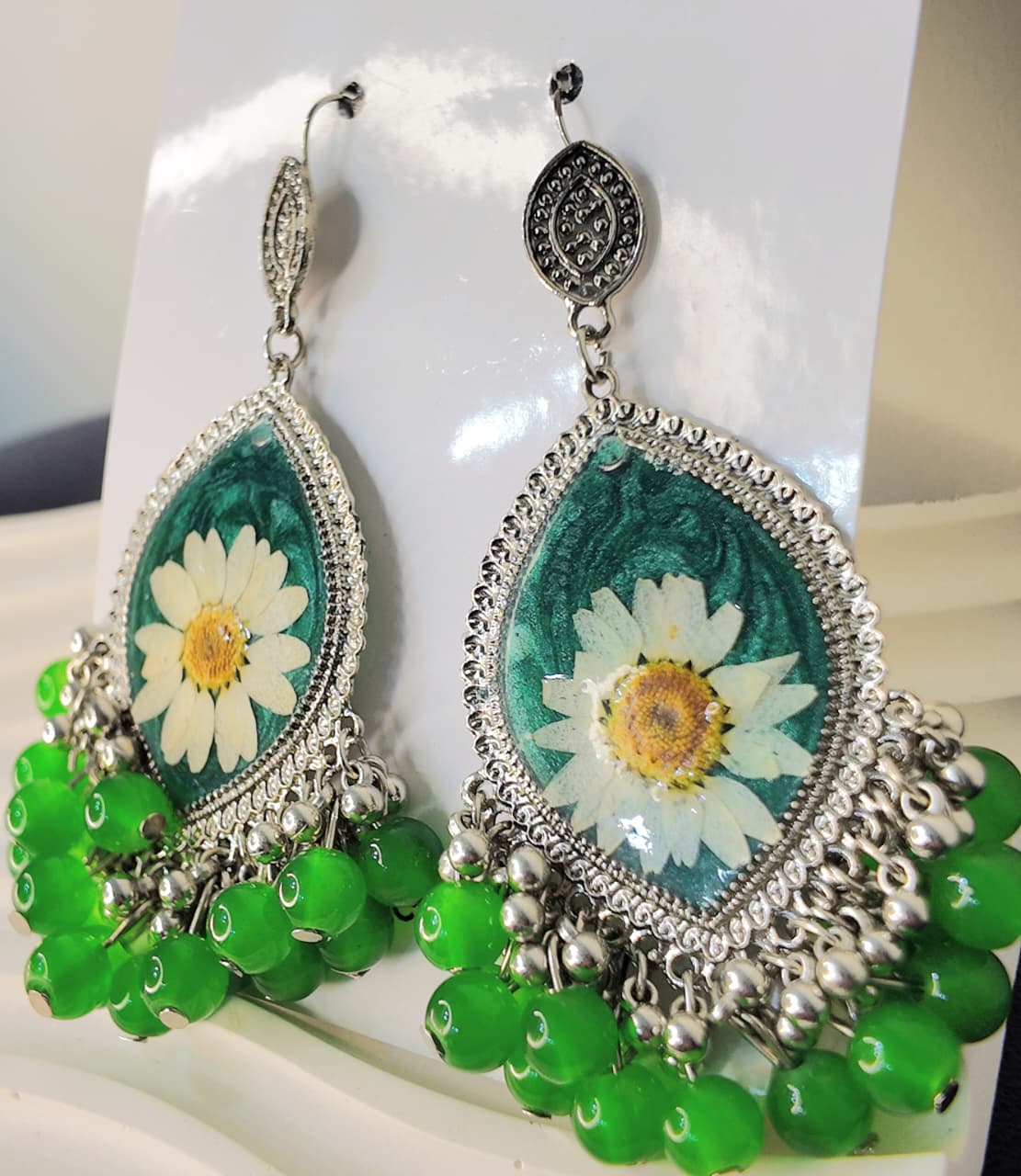 Silver Base Green Resin Jhumka with White & Yellow-Green Desi Flowers and Silver-Green Hangings – Signature Artisan Design